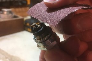 Cleaning spark plug.